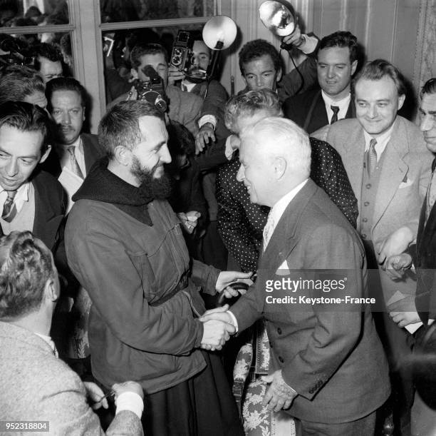 The American actor Charlie CHAPLIN shook hands with Father PIERRE. In a grand Parisian hotel, Charlie CHAPLIN met Father PIERRE and gave him a...