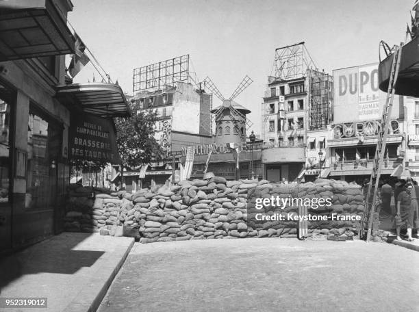 The top of "rue Fontaine" and "place Blanche" in Paris at the time of the liberation of the city in August 1944. Allied flags are hanging from the...