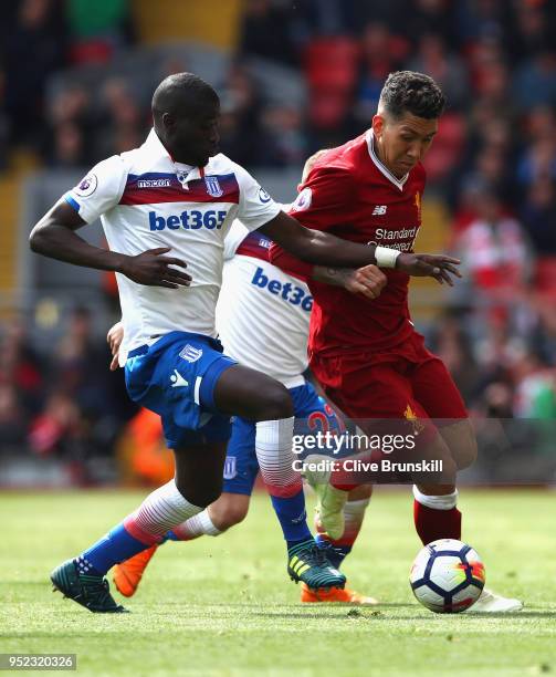 Roberto Firmino of Liverpool goes past Kurt Zouma of Stoke City during the Premier League match between Liverpool and Stoke City at Anfield on April...