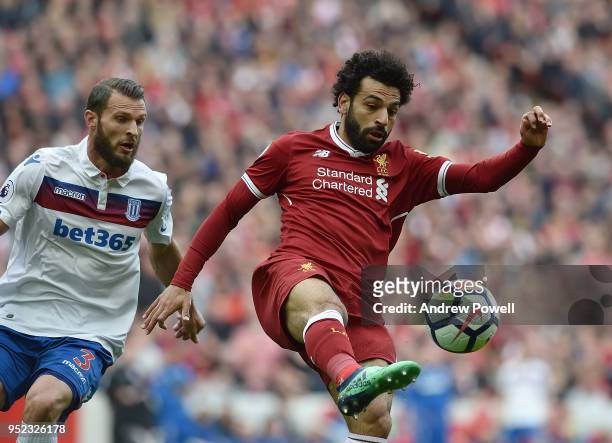 Mohamed Salah of Liverpool with Erik Pietersof Stoke City during the Premier League match between Liverpool and Stoke City at Anfield on April 28,...