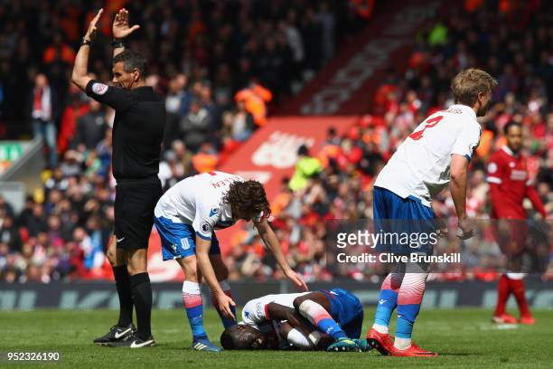 An injured Kurt Zouma of Stoke City is given treatment during the Premier League match between Liverpool and Stoke City at Anfield on April 28, 2018...