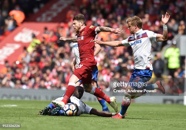 Alberto Moreno of Liverpool with Kurt zouma of Stoke City during the Premier League match between Liverpool and Stoke City at Anfield on April 28,...