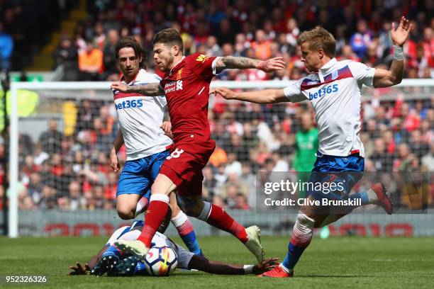 Alberto Moreno of Liverpool is tackled by Kurt Zouma of Stoke City during the Premier League match between Liverpool and Stoke City at Anfield on...