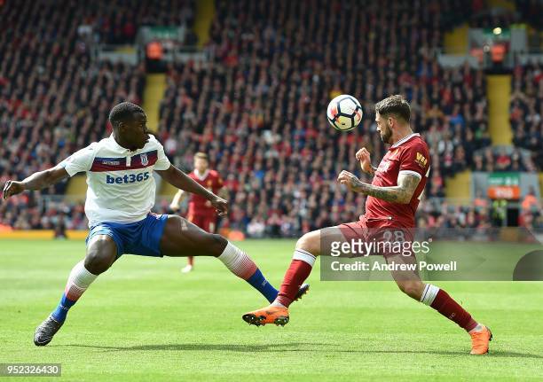 Danny Ings of Liverpool with Kurt Zouma of Stoke City during the Premier League match between Liverpool and Stoke City at Anfield on April 28, 2018...