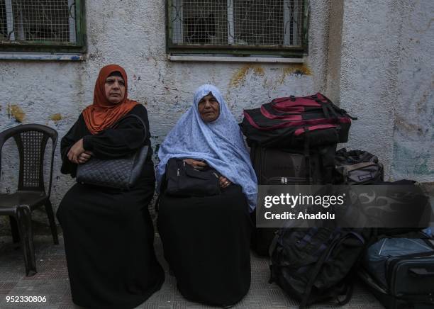 Palestinians wait in line for passport transactions to cross to Egypt following the opening of Rafah border gate in Khan Yunis, Gaza on April 28,...