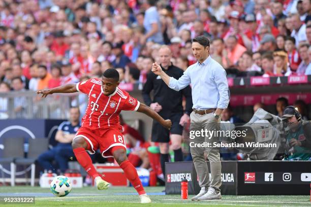 Franck Evina of Bayern Muenchen plays the ball in front of head coach Niko Kovac of Frankfurt during the Bundesliga match between FC Bayern Muenchen...