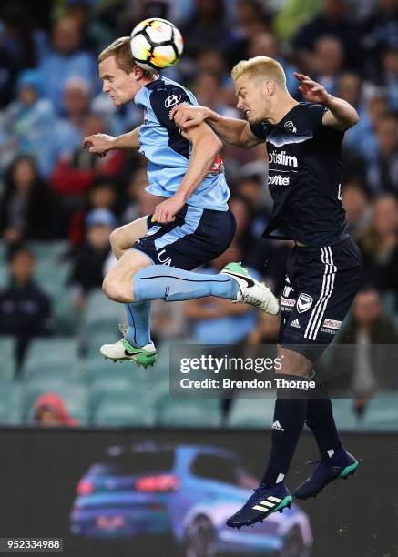 Matthew Simon of Sydney competes with James Donachie of the Victory during the A-League Semi Final match between Sydney FC and Melbourne Victory at...