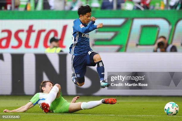 Paul Verhaegh of Wolfsburg tires to stop Tatsuya Ito of Hamburg during the Bundesliga match between VfL Wolfsburg and Hamburger SV at Volkswagen...