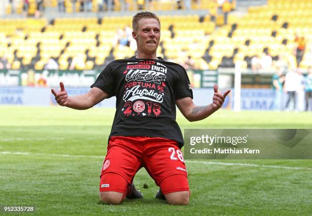 Rouwen Hennings of Duesseldorf jubilates after moving up into the Bundesliga after the Second Bundesliga match between SG Dynamo Dresden and Fortuna...