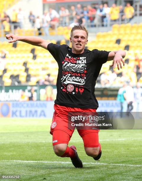 Rouwen Hennings of Duesseldorf jubilates after moving up into the Bundesliga after the Second Bundesliga match between SG Dynamo Dresden and Fortuna...