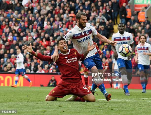 Roberto Firmino of Liverpool brought down by Erik Pieters of Stoke City during the Premier League match between Liverpool and Stoke City at Anfield...