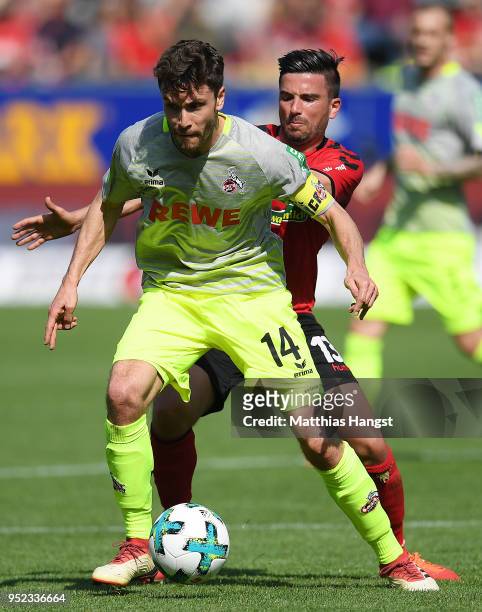 Jonas Hector of Koeln fights for the ball with Marco Terrazzino of Freiburg during the Bundesliga match between Sport-Club Freiburg and 1. FC Koeln...