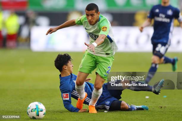 Tatsuya Ito of Hamburg is being fouled by William of Wolfsburg during the Bundesliga match between VfL Wolfsburg and Hamburger SV at Volkswagen Arena...