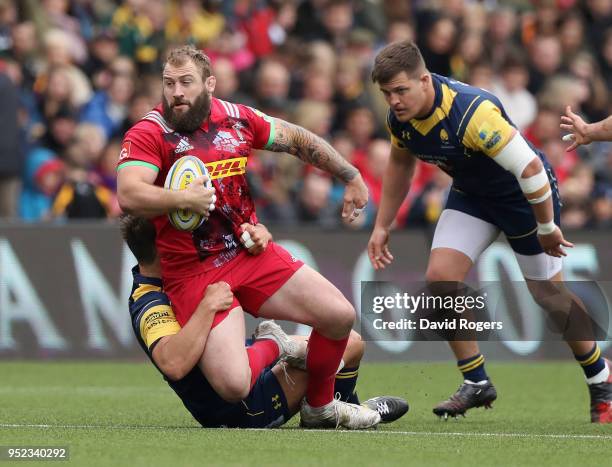 Joe Marler of Harlequins is tackled by Donncha O'Callaghan during the Aviva Premiership match between Worcester Warriors and Harlequins at Sixways...