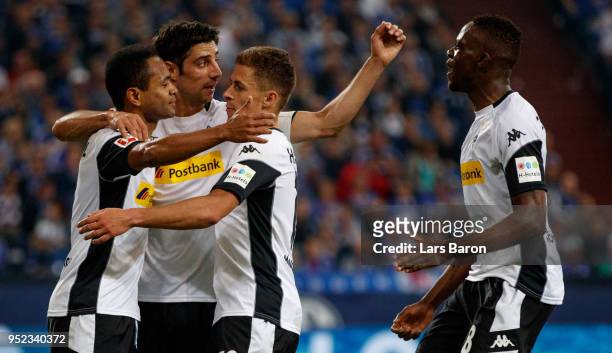 Raffael of Moenchengladbach celebrates with team mates after scoring his teams first goal during the Bundesliga match between FC Schalke 04 and...
