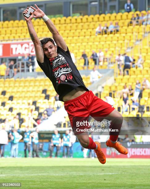 Kaan Ayhan of Duesseldorf jubilates after moving up into the Bundesliga after the Second Bundesliga match between SG Dynamo Dresden and Fortuna...