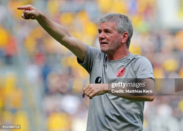 Head coach Friedhelm Funkel of Duesseldorf jubilates after moving up into the Bundesliga after the Second Bundesliga match between SG Dynamo Dresden...