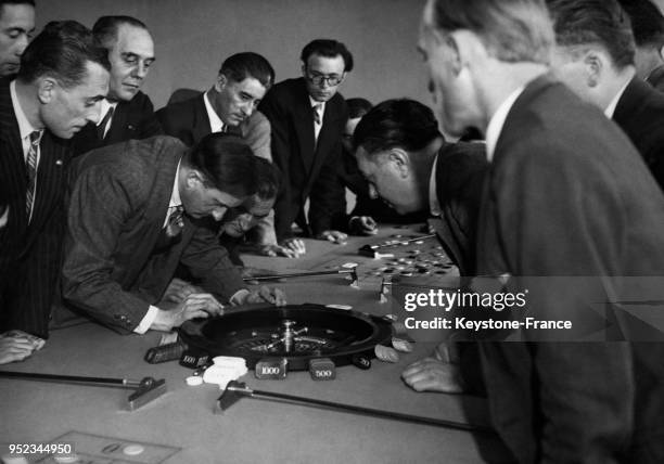 Vérification de l'équilibre d'une roulette de jeu à l'aide du niveau d'eau dans une école de formation des croupiers à Paris, France.