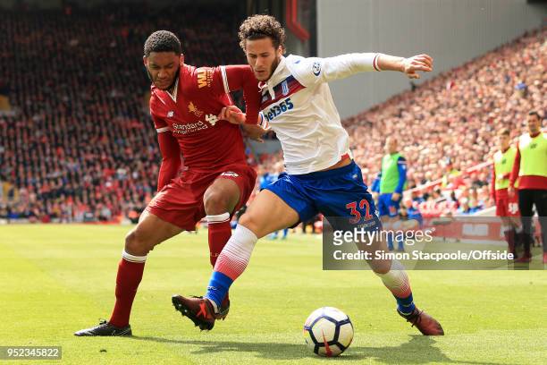 Ramadan Sobhi of Stoke holds off Joe Gomez of Liverpool during the Premier League match between Liverpool and Stoke City at Anfield on April 28, 2018...