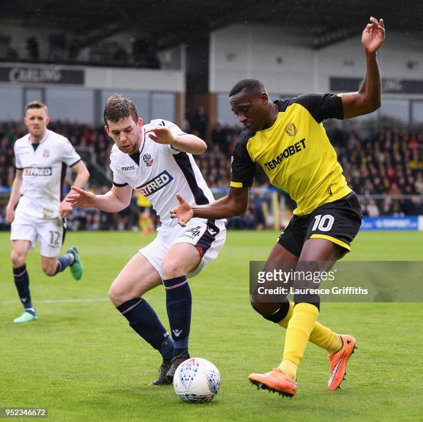 Lucas Akins of Burton Albion is challenged by Jon Flanagan of Bolton Wanderers during the Sky Bet Championship match between Burton Albion and Bolton...