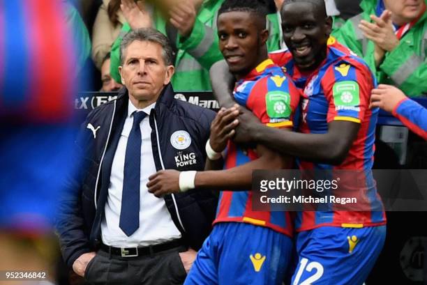 Wilfried Zaha of Crystal Palace celebrates scoring his sides first goal with teammates as Claude Puel, Manager of Leicester City watches on during...