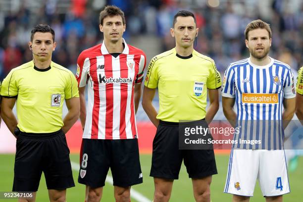 Ander Iturraspe of Athletic Bilbao, referee Jose Sanchez, Asier Illarramendi of Real Sociedad during the La Liga Santander match between Real...