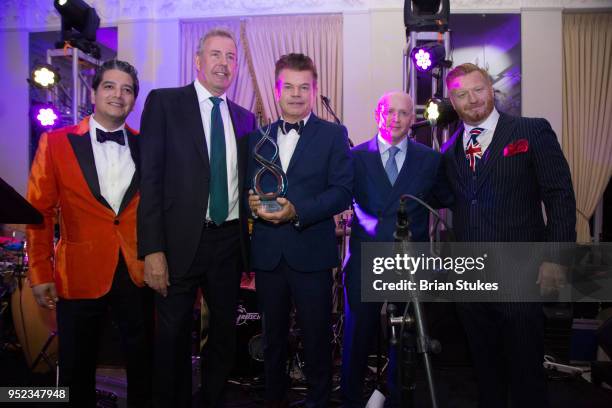 Dj Paul Oakenfold is presented with award during "Come Together" White House Correspondents' Dinner Pre-Party at The British Embassy on April 27,...