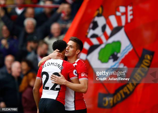 Dusan Tadic celebrates scoring his side's first goal with Nathan Redmond of Southampton during the Premier League match between Southampton and AFC...