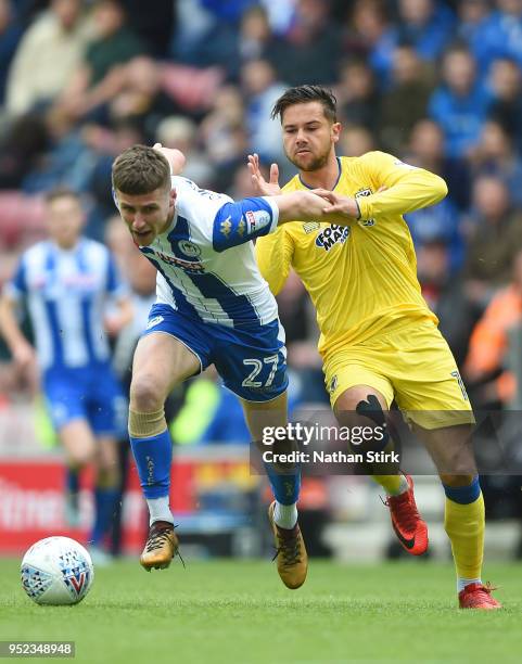 Ryan Colclough of Wigan Athletic holds off Harry Forrester of AFC Wimbledon during the Sky Bet League One match between Wigan Athletic and A.F.C....