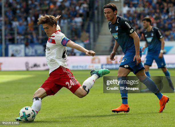 Gotoku Sakai of Hamburg and Nico Schulz of Hoffenheim battle for the ball during the Bundesliga match between TSG 1899 Hoffenheim and Hamburger SV at...