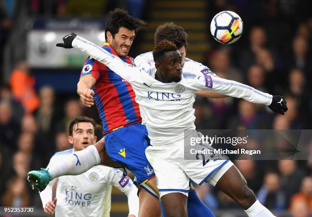 James Tomkins of Crystal Palace wins a header over Wilfred Ndidi of Leicester City during the Premier League match between Crystal Palace and...