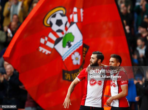Dusan Tadic of Southampton celebrates scoring his side's first goal with Charlie Austin during the Premier League match between Southampton and AFC...
