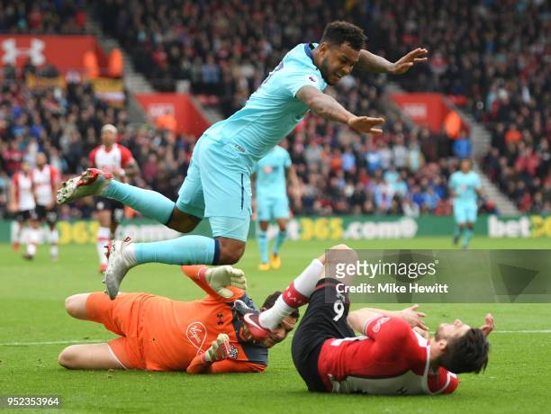 Joshua King of AFC Bournemouth lands on Wesley Hoedt of Southampton after clashing with Alex McCarthy of Southampton during the Premier League match...