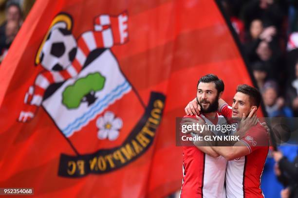Southampton's Serbian midfielder Dusan Tadic celebrates with Southampton's English striker Charlie Austin for scoring the opening goal during the...