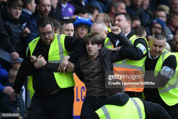 Fan is escorted out of the stadium during the Sky Bet Championship match between Burton Albion and Bolton Wanderers at Pirelli Stadium on April 28,...