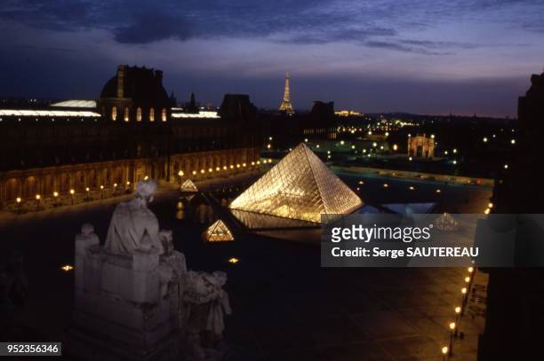 Vue des toits du Louvre de nuit sur la Cour Napoléon et la Pyramide du Louvre, Musée du Louvre, Paris.