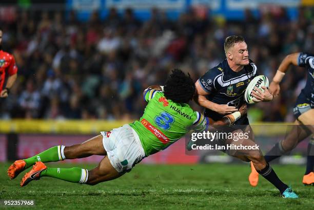 Coen Hess of the Cowboys is tackled by Iosia Soliola of the Raiders during the round eight NRL match between the North Queensland Cowboys and the...