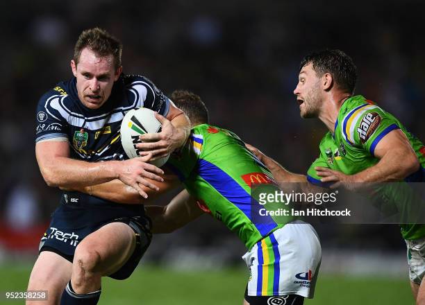 Michael Morgan of the Cowboys is tackled by Aidan Sezer of the Raiders during the round eight NRL match between the North Queensland Cowboys and the...