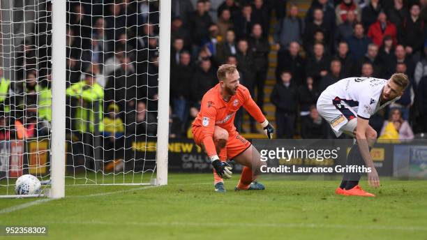 Ben Alnwick and Mark Beevers of Bolton Wanderers watch as the ball crosses the line, as Lucas Akins of Burton Albion scores his side's second goal...