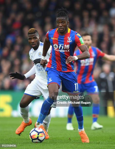 Wilfried Zaha of Crystal Palace is closed down by Kelechi Iheanacho of Leicester City during the Premier League match between Crystal Palace and...