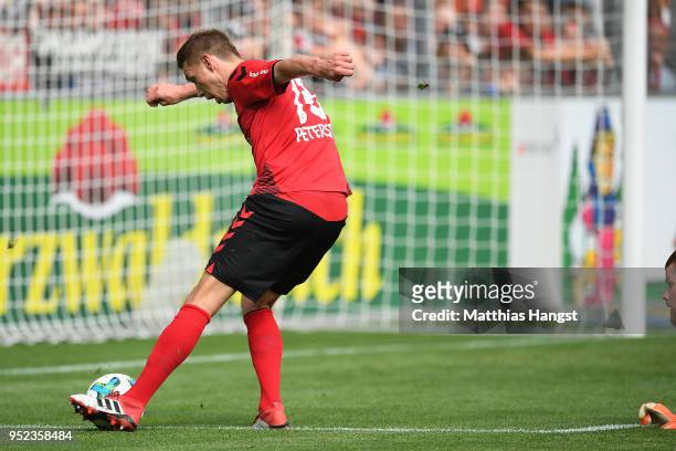 Nils Petersen of Freiburg scores a goal past goalkeeper Timo Horn of Koeln to make it 2:0 during the Bundesliga match between Sport-Club Freiburg and...