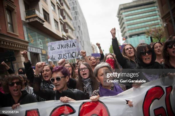 People shout slogans and hold banners during a demonstration against the verdict of the 'La Manada' gang case on April 27, 2018 in Pamplona, Spain....