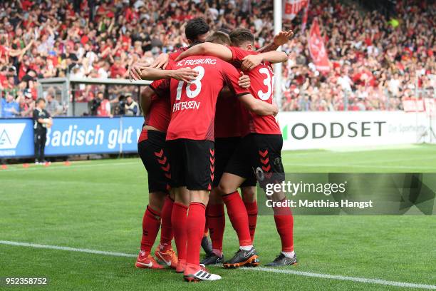 Nils Petersen of Freiburg is celebrated by his team after he scored a goal to make it 2:0 during the Bundesliga match between Sport-Club Freiburg and...
