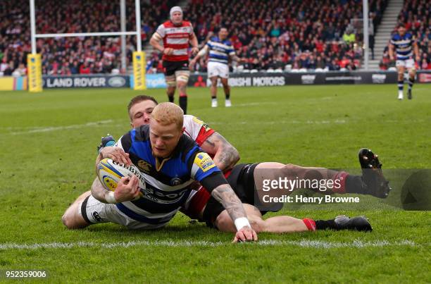 Tom Homer of Bath scores their fourth try despite the efforts of Jason Woodward of Gloucester during the Aviva Premiership match between Gloucester...