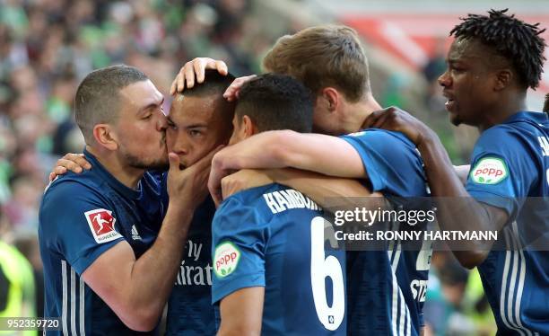 Hamburg's US striker Bobby Wood is congratulated by Hamburg's Greek defender Kyriakos Papadopoulos and other teammates after scoring his team's...