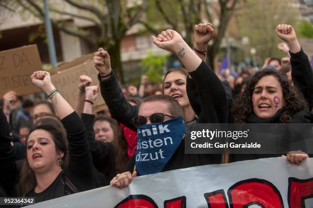 People shout slogans and hold banners during a demonstration against the verdict of the 'La Manada' gang case on April 27, 2018 in Pamplona, Spain....