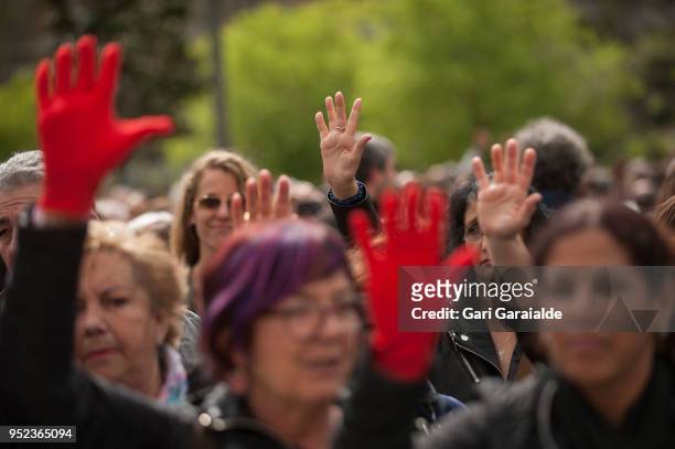 People hold up their and shout slogans during a demonstration against the verdict of the 'La Manada' gang case on April 27, 2018 in Pamplona, Spain....