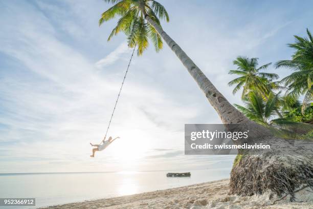 tropical fun in the philippines, girl on rope swing, dreamlike vacations on island - island of siquijor stock pictures, royalty-free photos & images