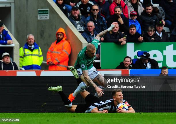 Matt Ritchie of Newcastle United lays on the ground holding the ball after being fouled by James McClean of West Bromwich Albion during the Premier...