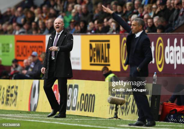 Sean Dyche, Manager of Burnley and Chris Hughton, Manager of Brighton and Hove Albion give instructions during the Premier League match between...